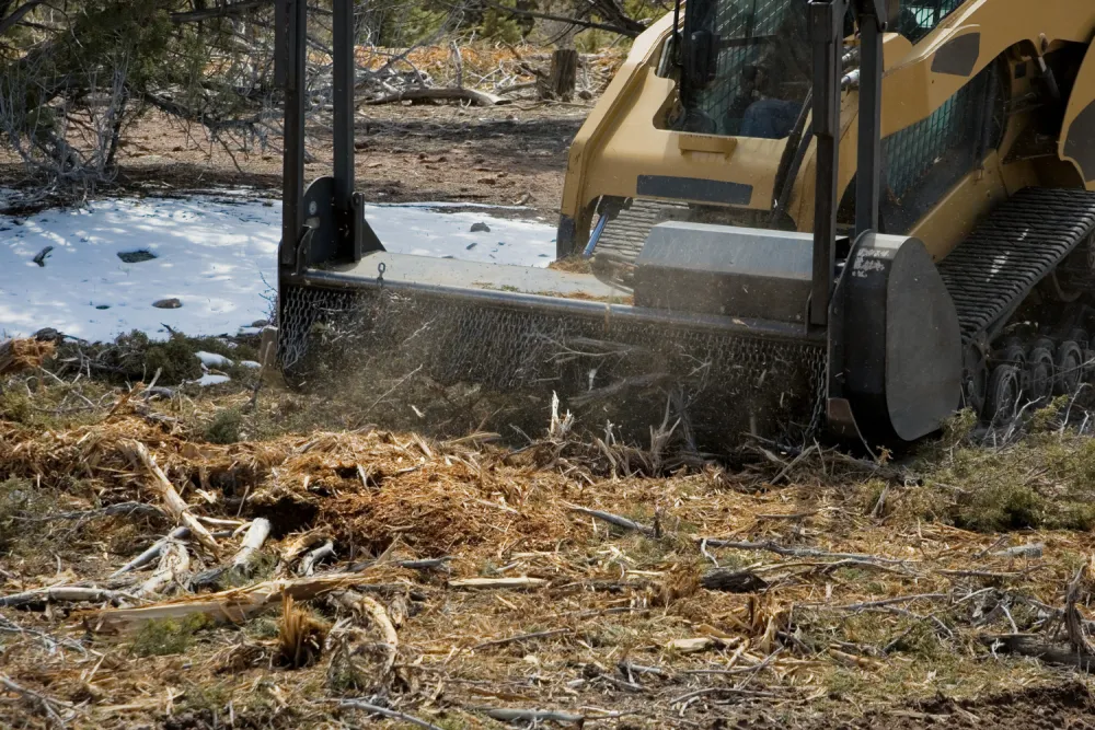 Forestry mulcher grinding dense brush into mulch on a property in Spring, TX